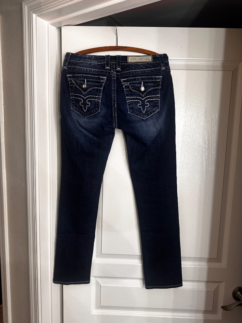Rock Revival Denim jeans with rhinestone accents and iconic rock revival logo on